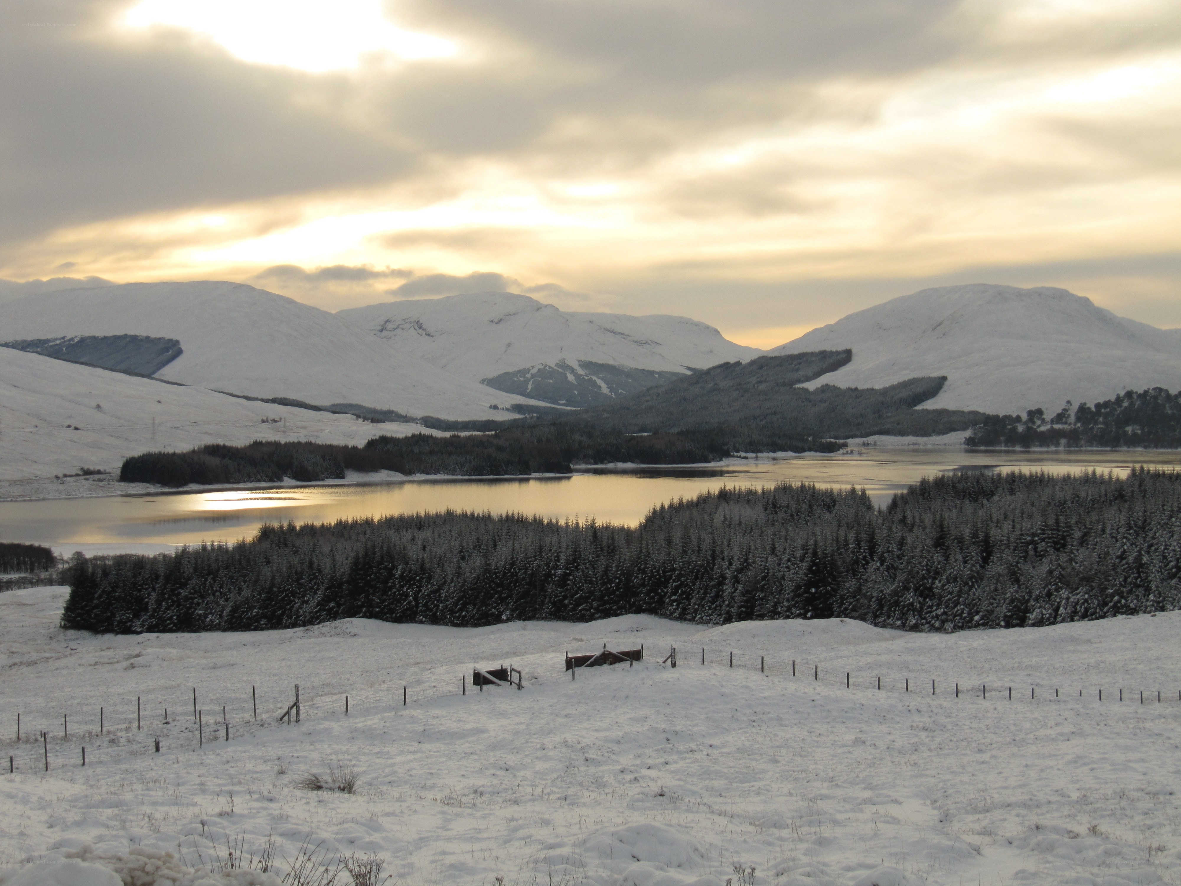 Snowy mountain lake at sunset