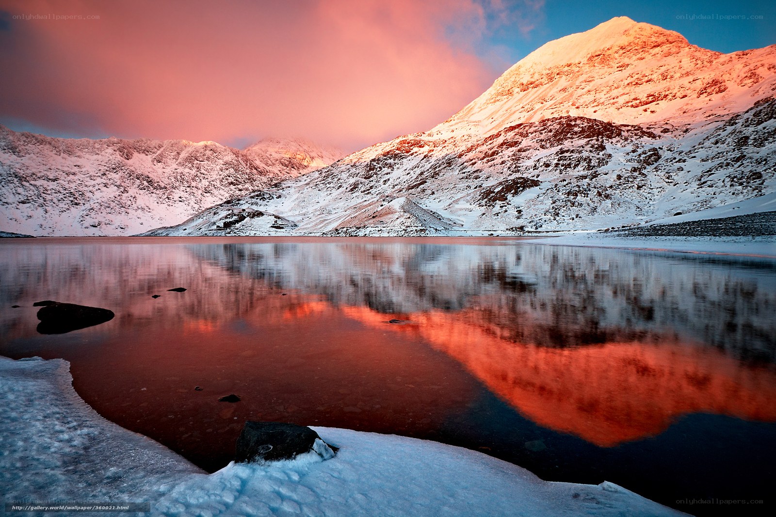 Snowy mountain lake at sunset