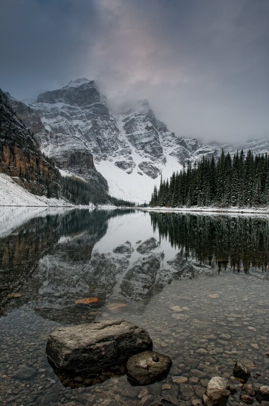 Snowy mountain lake reflection