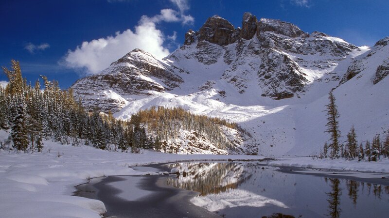 Snowy mountain lake reflection