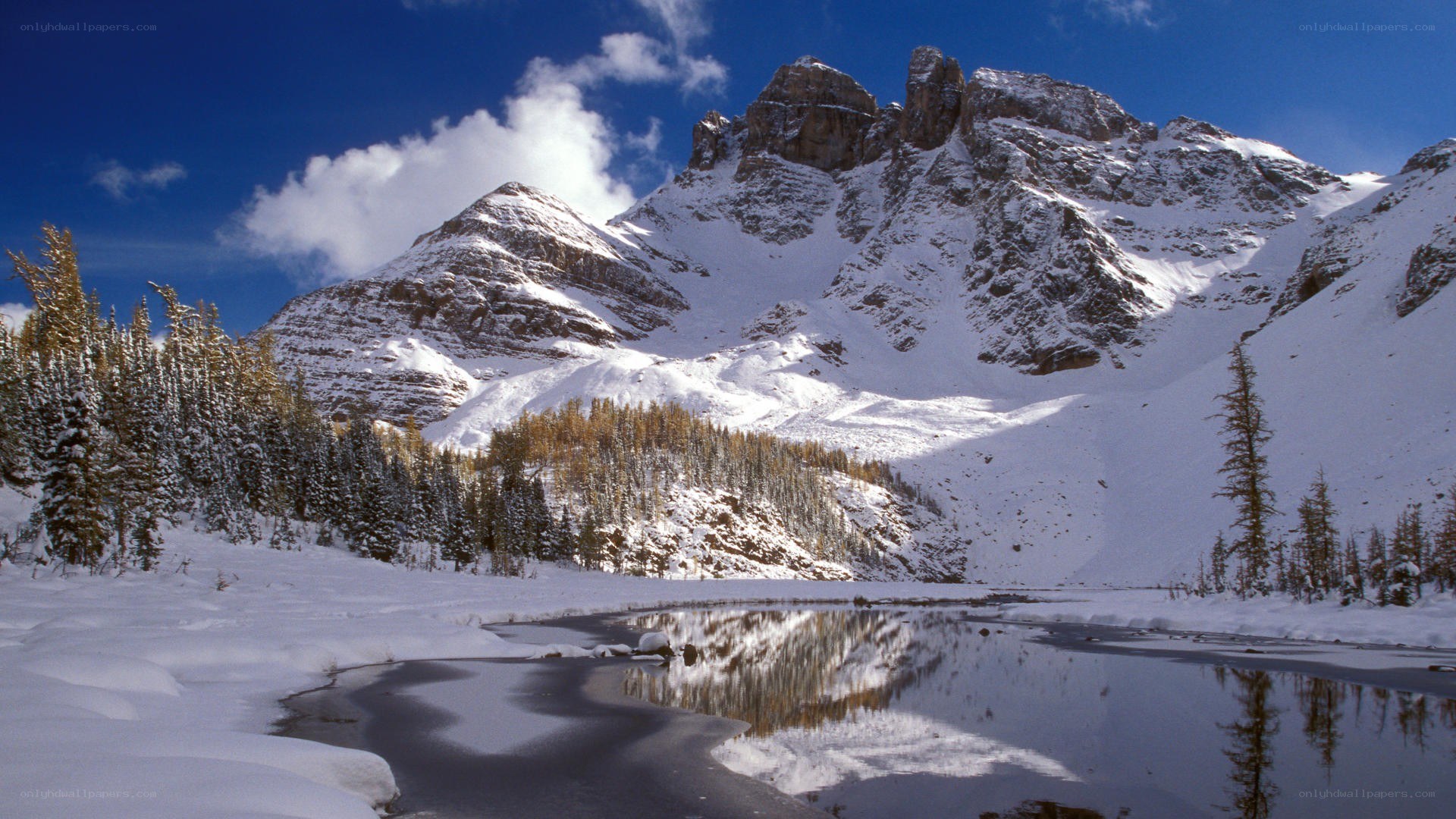 Snowy mountain lake reflection