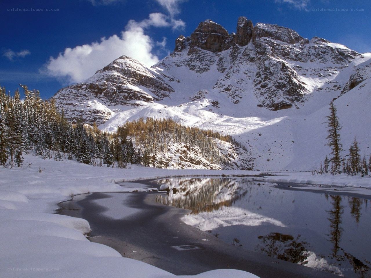 Snowy mountain lake reflection