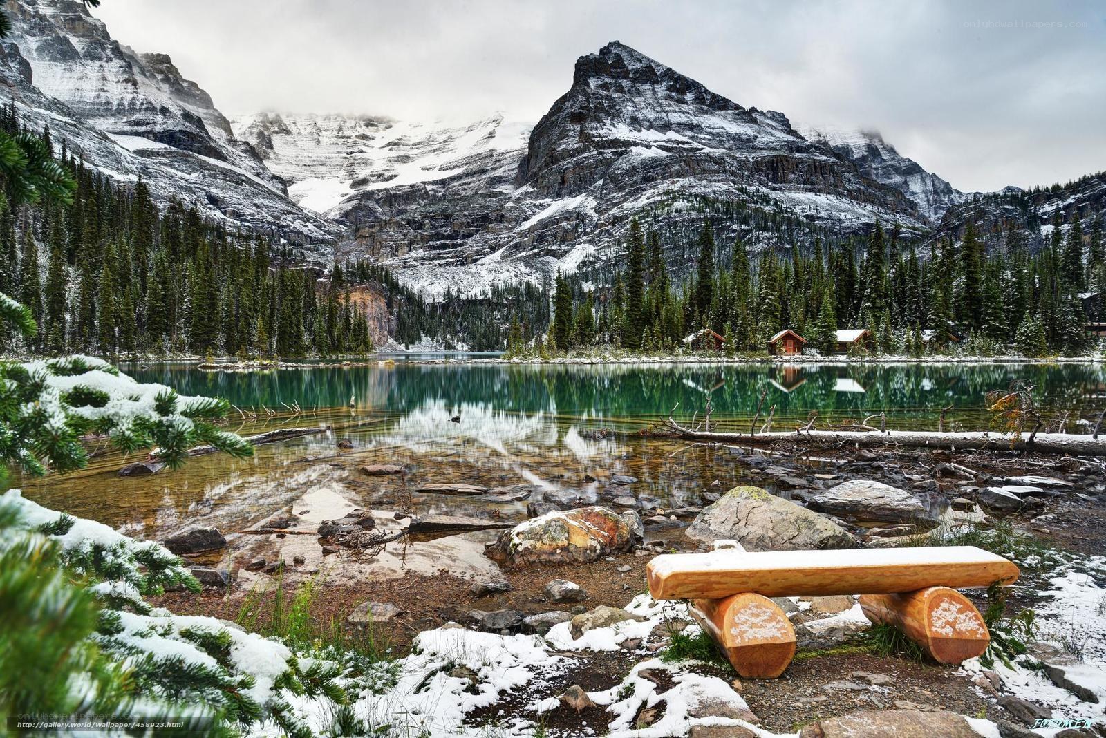 Snowy mountain lake with cabin