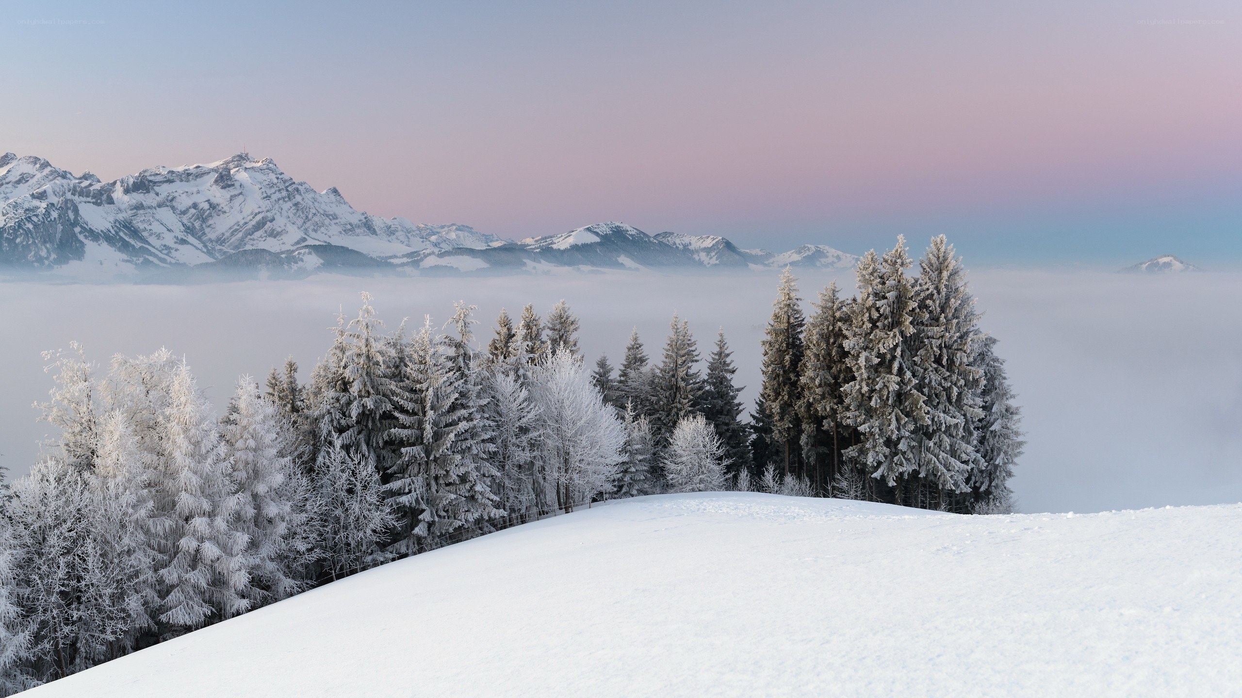 Snowy mountain landscape at dawn