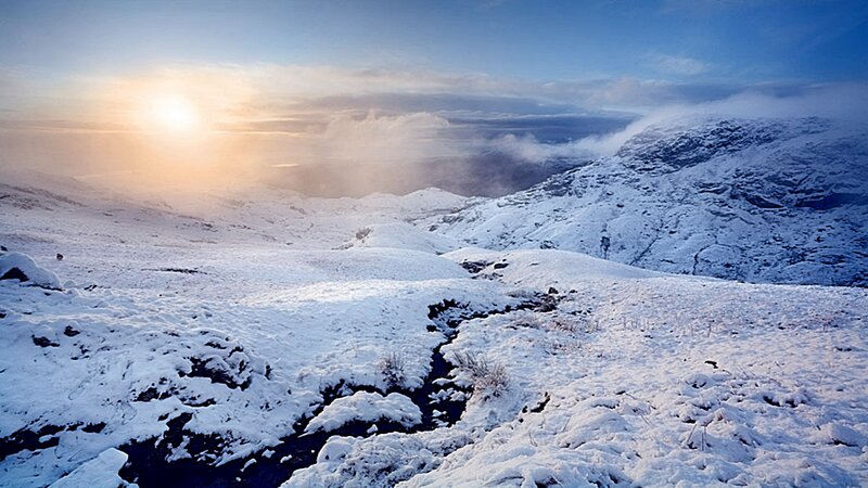 Snowy mountain landscape at sunrise
