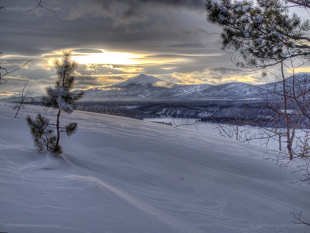 Snowy mountain landscape at sunset