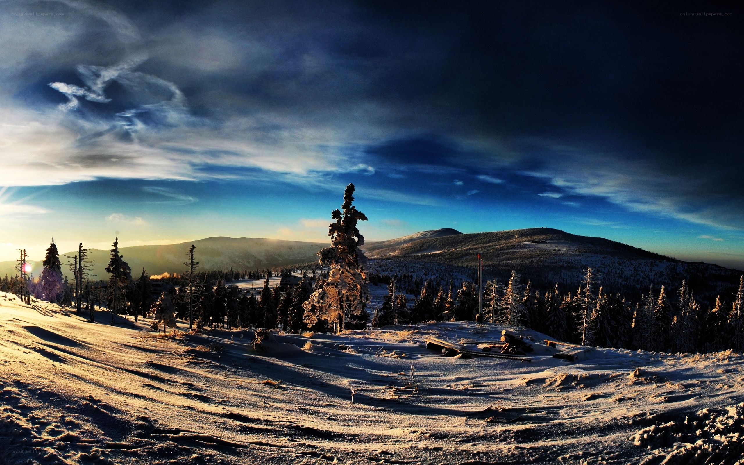 Snowy mountain landscape at sunset