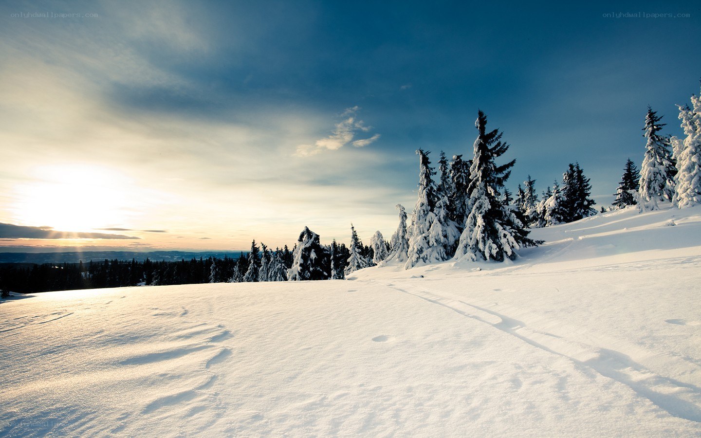 Snowy mountain landscape at sunset