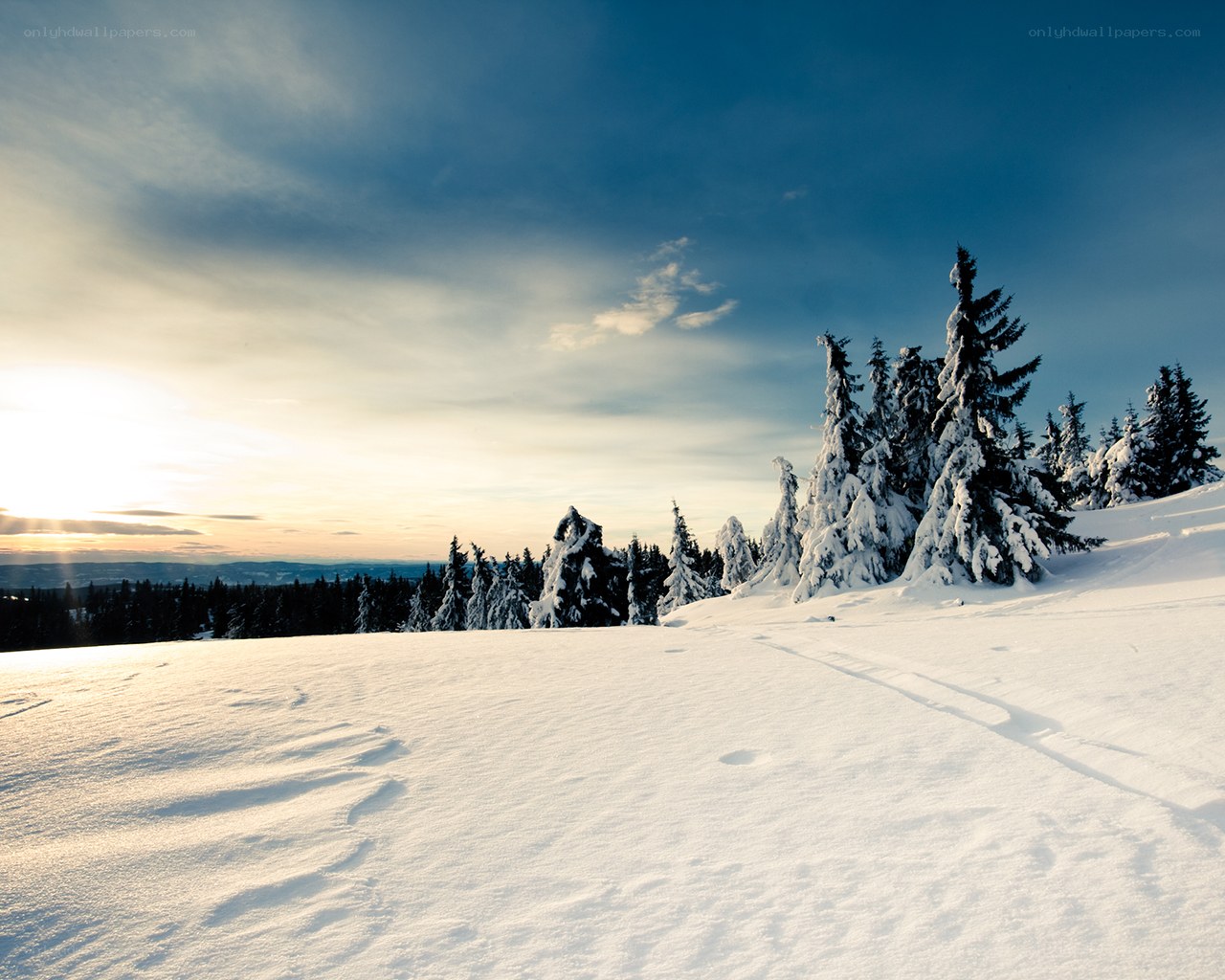 Snowy mountain landscape at sunset