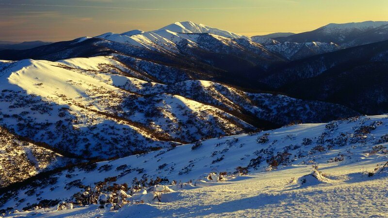 Snowy mountain landscape at sunset