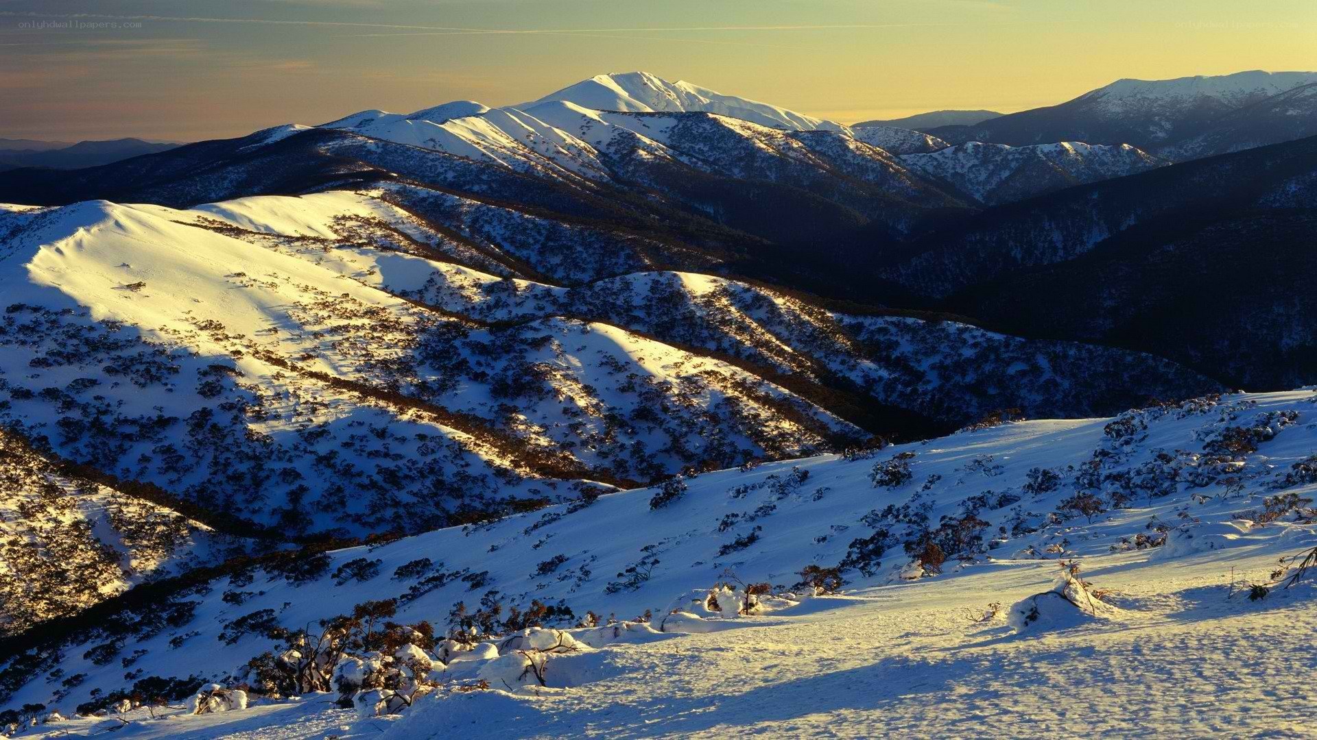 Snowy mountain landscape at sunset
