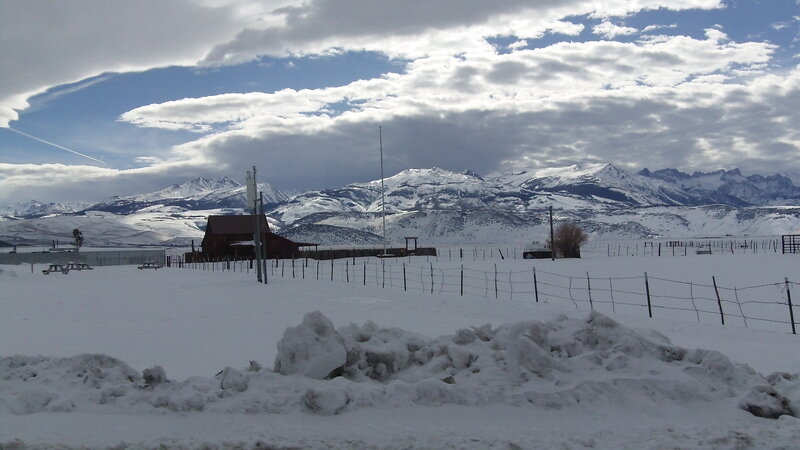 Snowy mountain landscape with barn