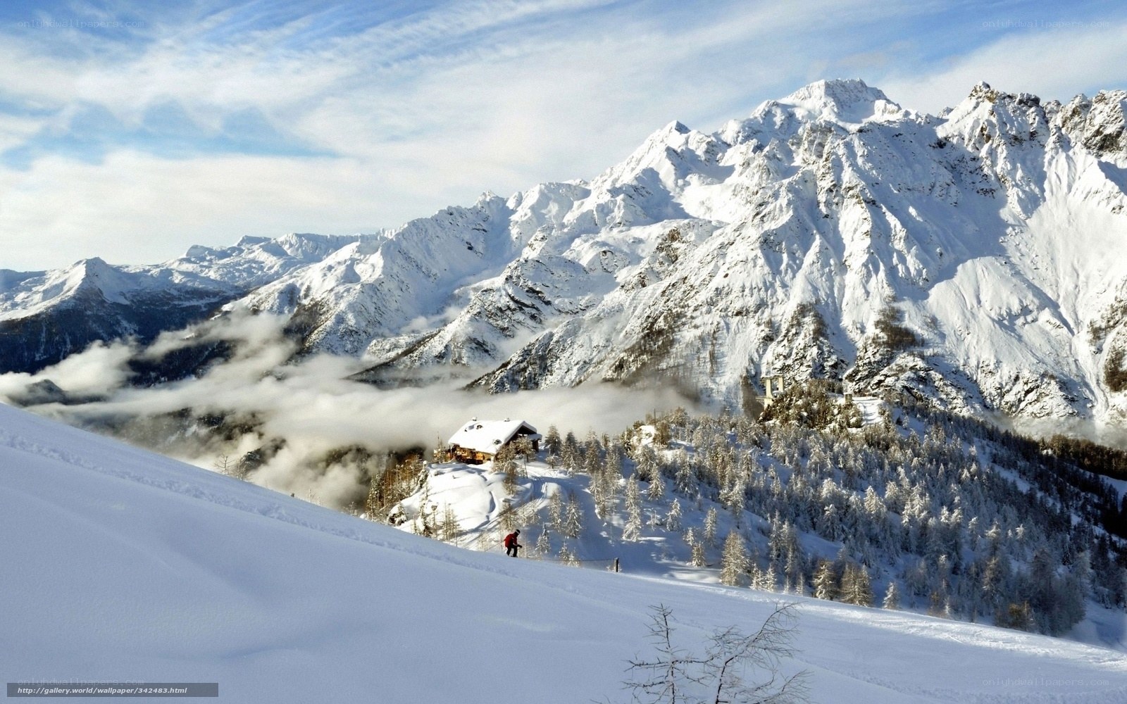 Snowy mountain landscape with cabin