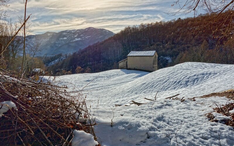 Snowy mountain landscape with cabin
