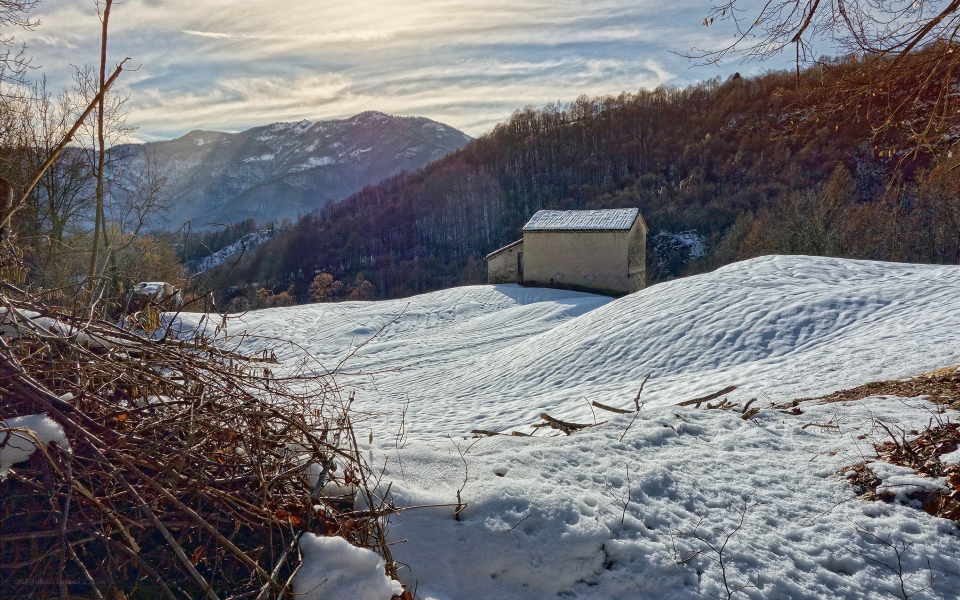Snowy mountain landscape with cabin