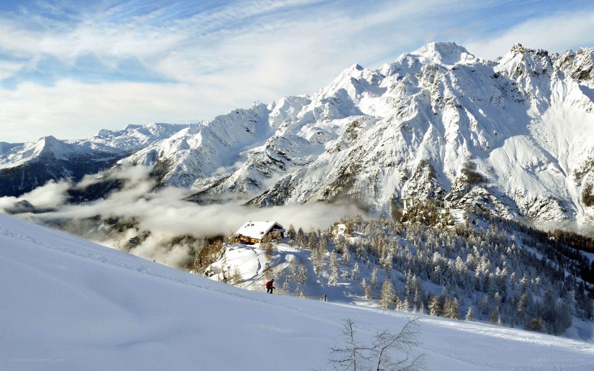 Snowy mountain landscape with cabin