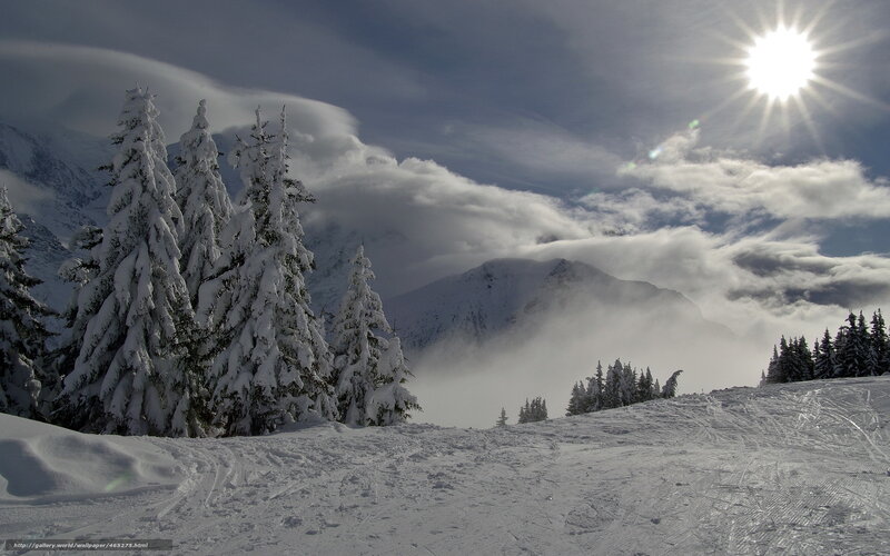 Snowy mountain landscape with sun