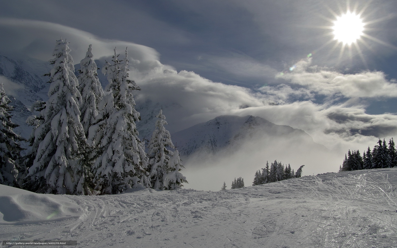 Snowy mountain landscape with sun