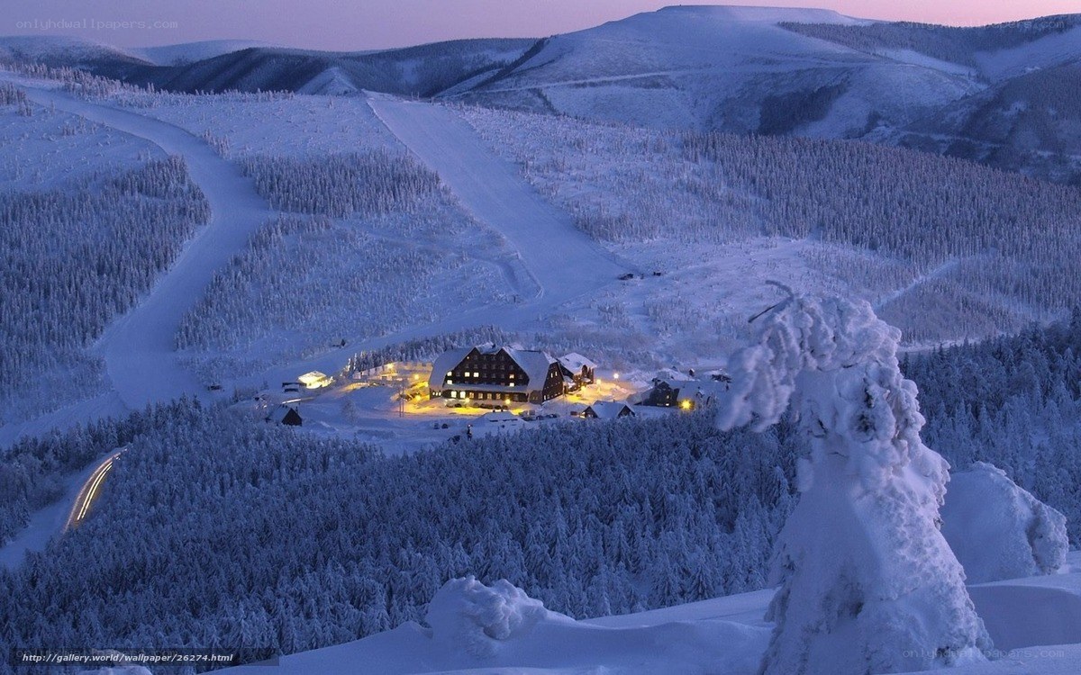 Snowy mountain lodge at dusk