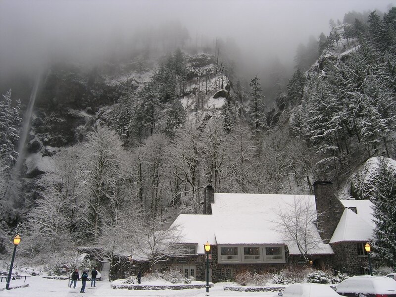 Snowy mountain lodge with waterfall
