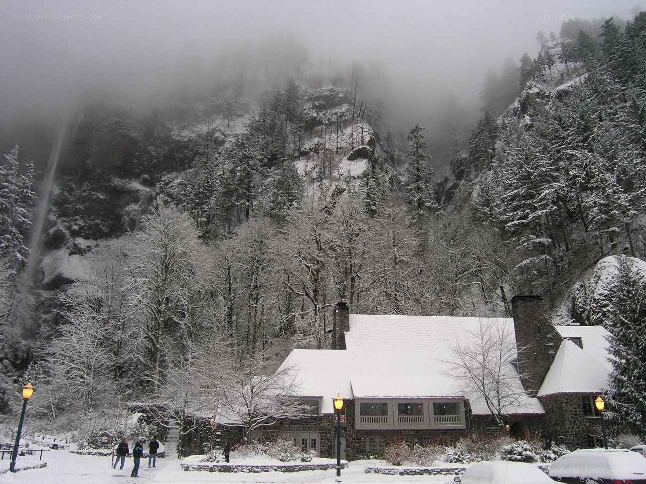 Snowy mountain lodge with waterfall