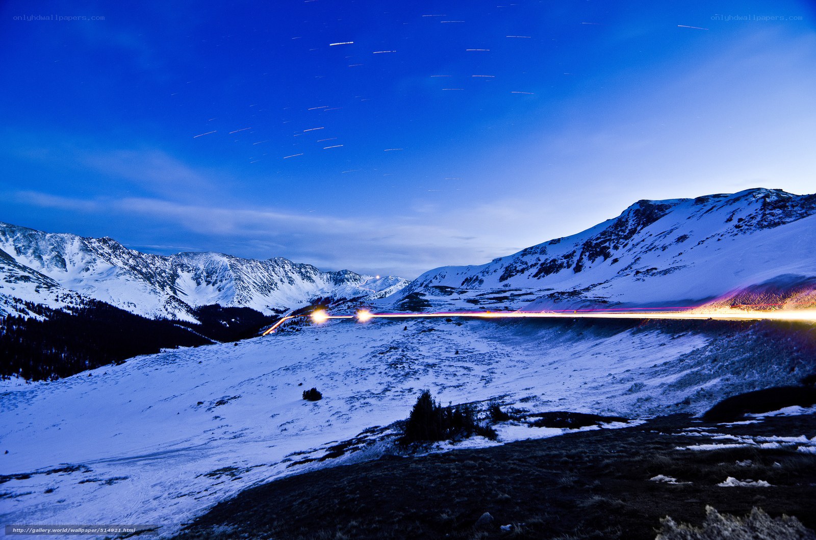 Snowy mountain night with light trails