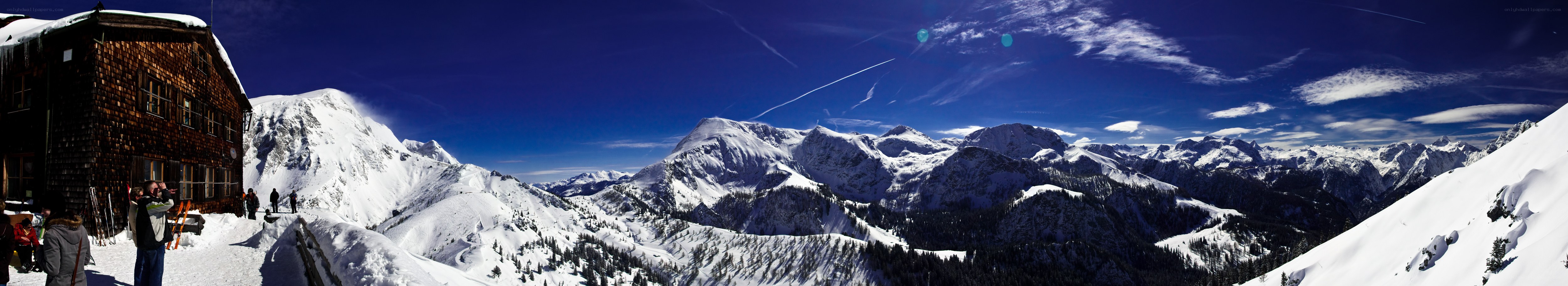 Snowy mountain panorama with lodge