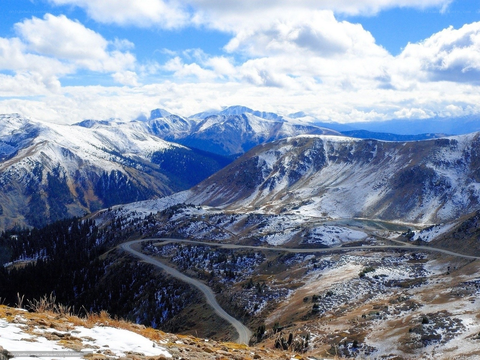 Snowy mountain pass with winding road