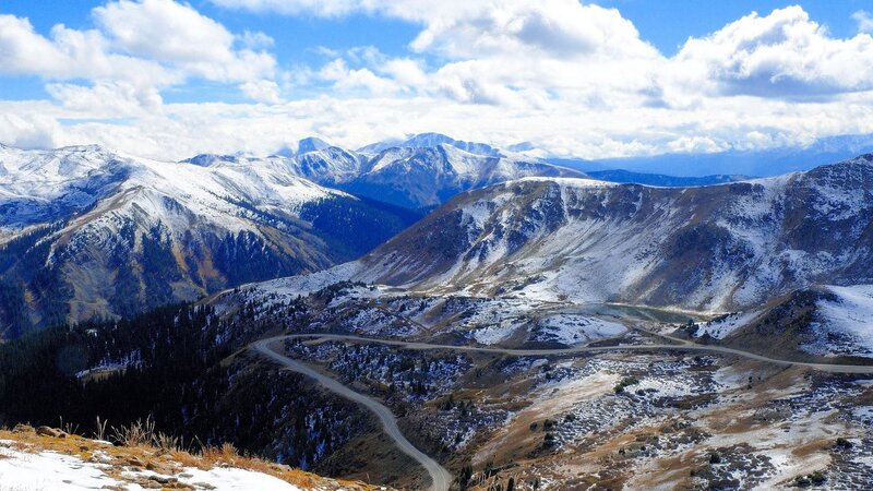 Snowy mountain pass with winding road