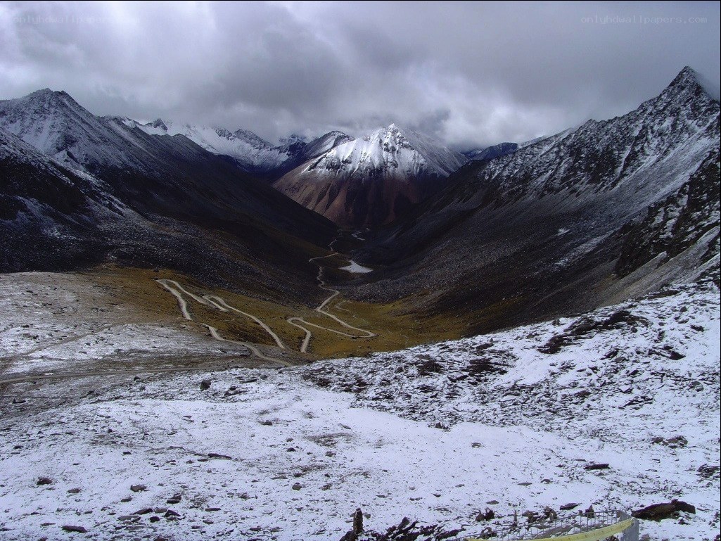 Snowy mountain pass with winding road