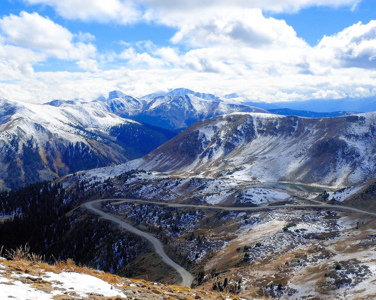 Snowy mountain pass with winding road