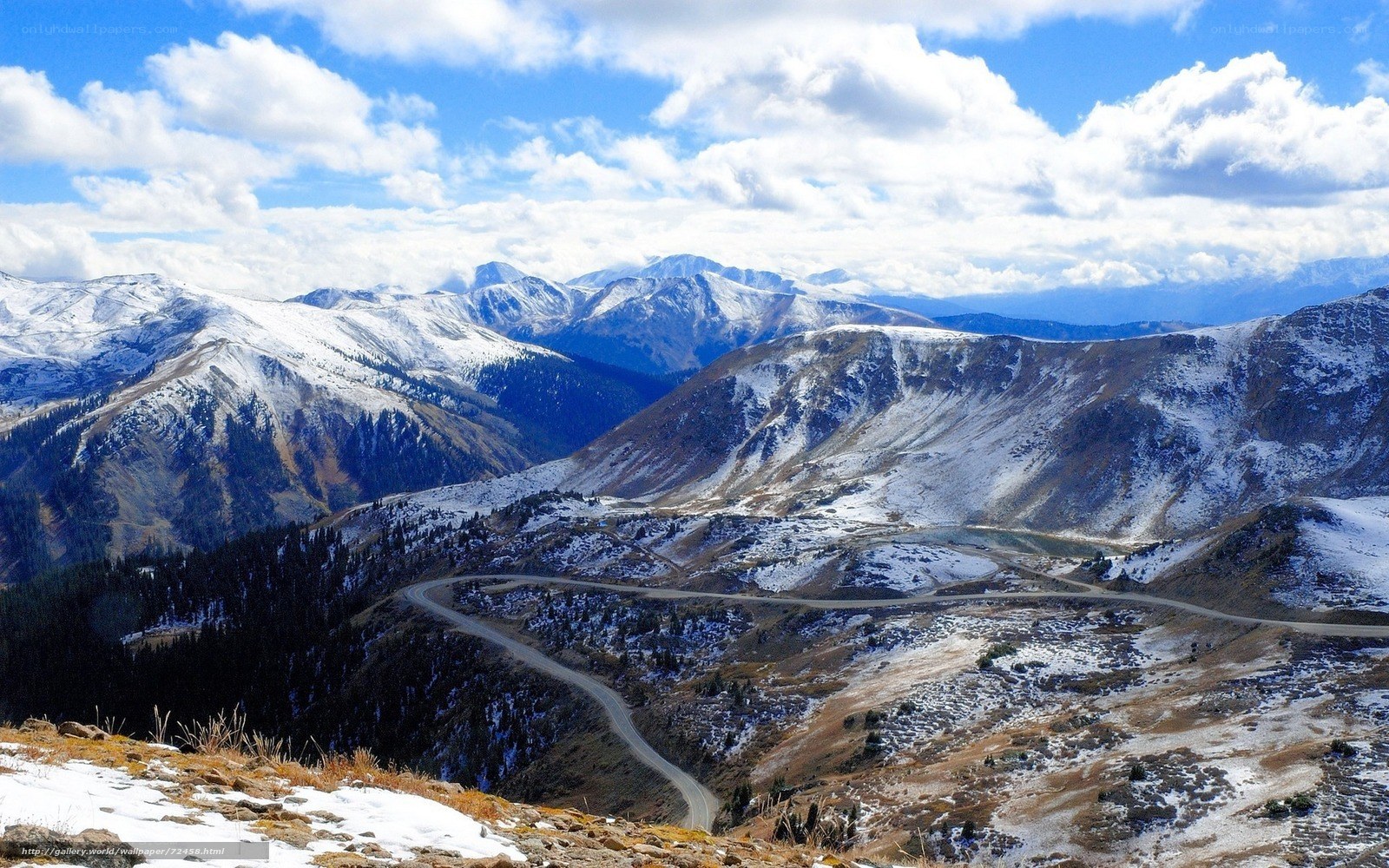 Snowy mountain pass with winding road