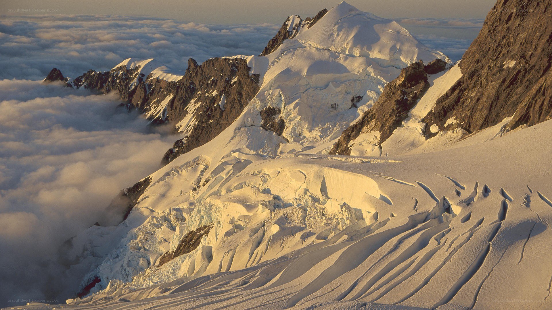 Snowy mountain peak above clouds