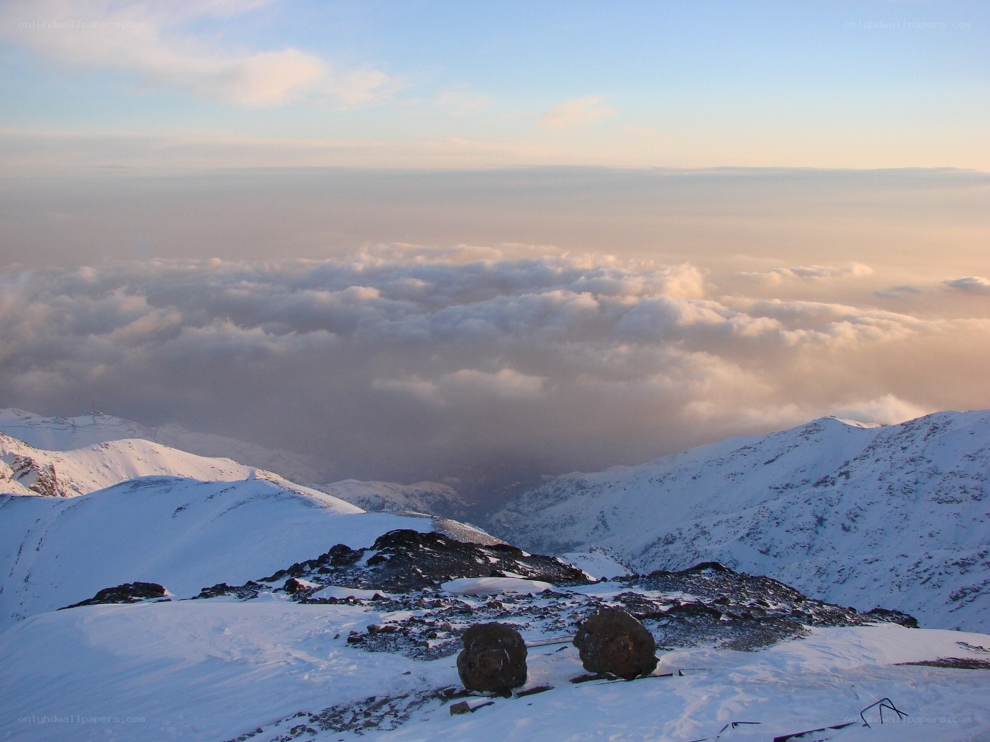 Snowy mountain peak above clouds