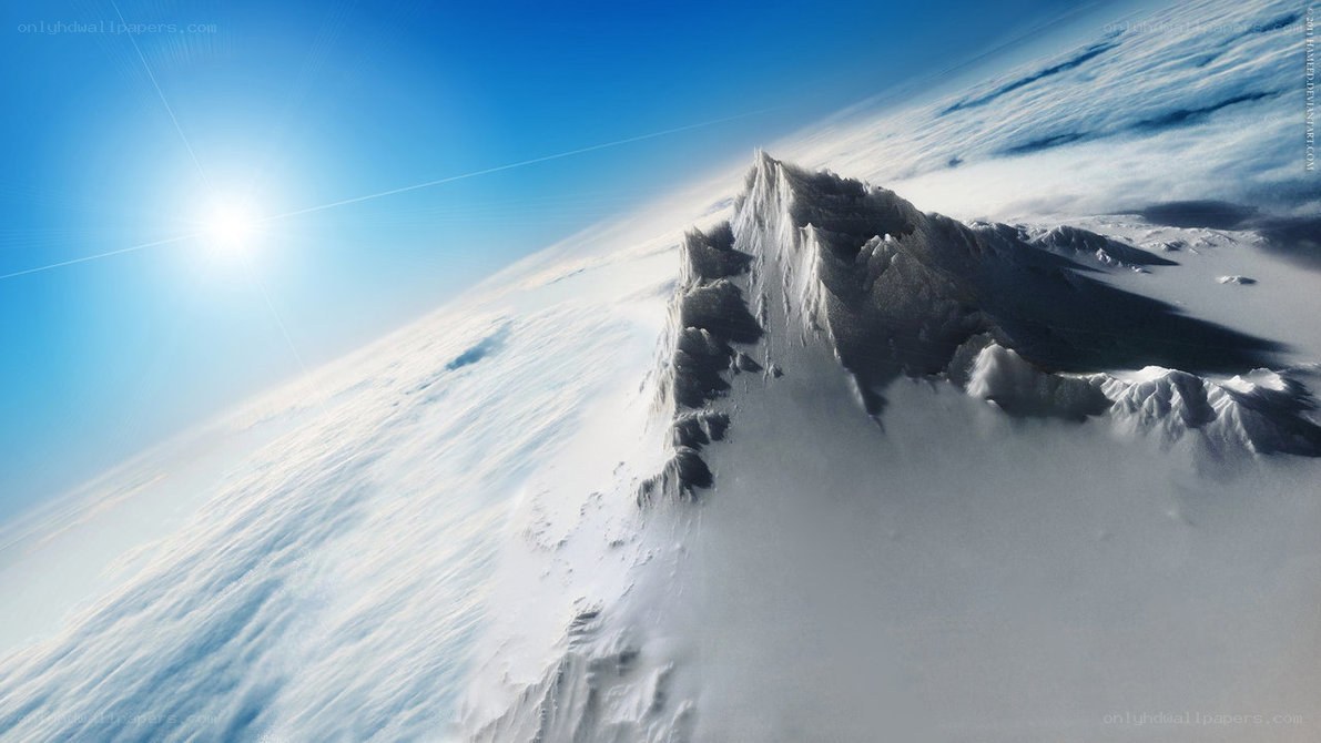 Snowy mountain peak above clouds