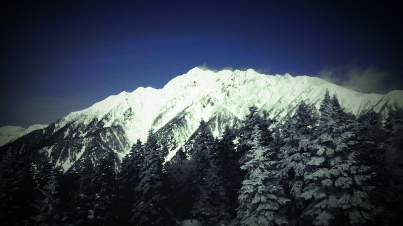 Snowy mountain peak at night