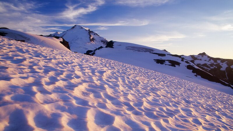 Snowy mountain peak at sunrise