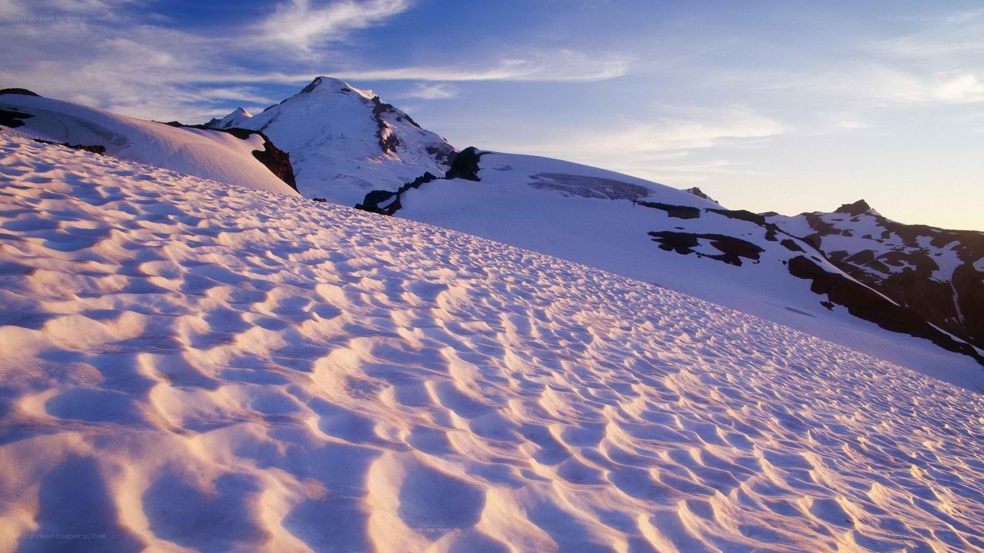 snowy mountain peak at sunrise
