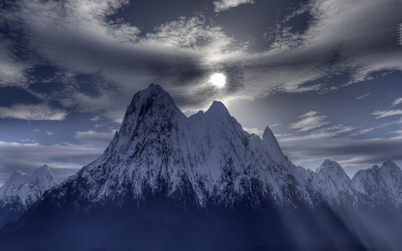 Snowy mountain peak at sunset