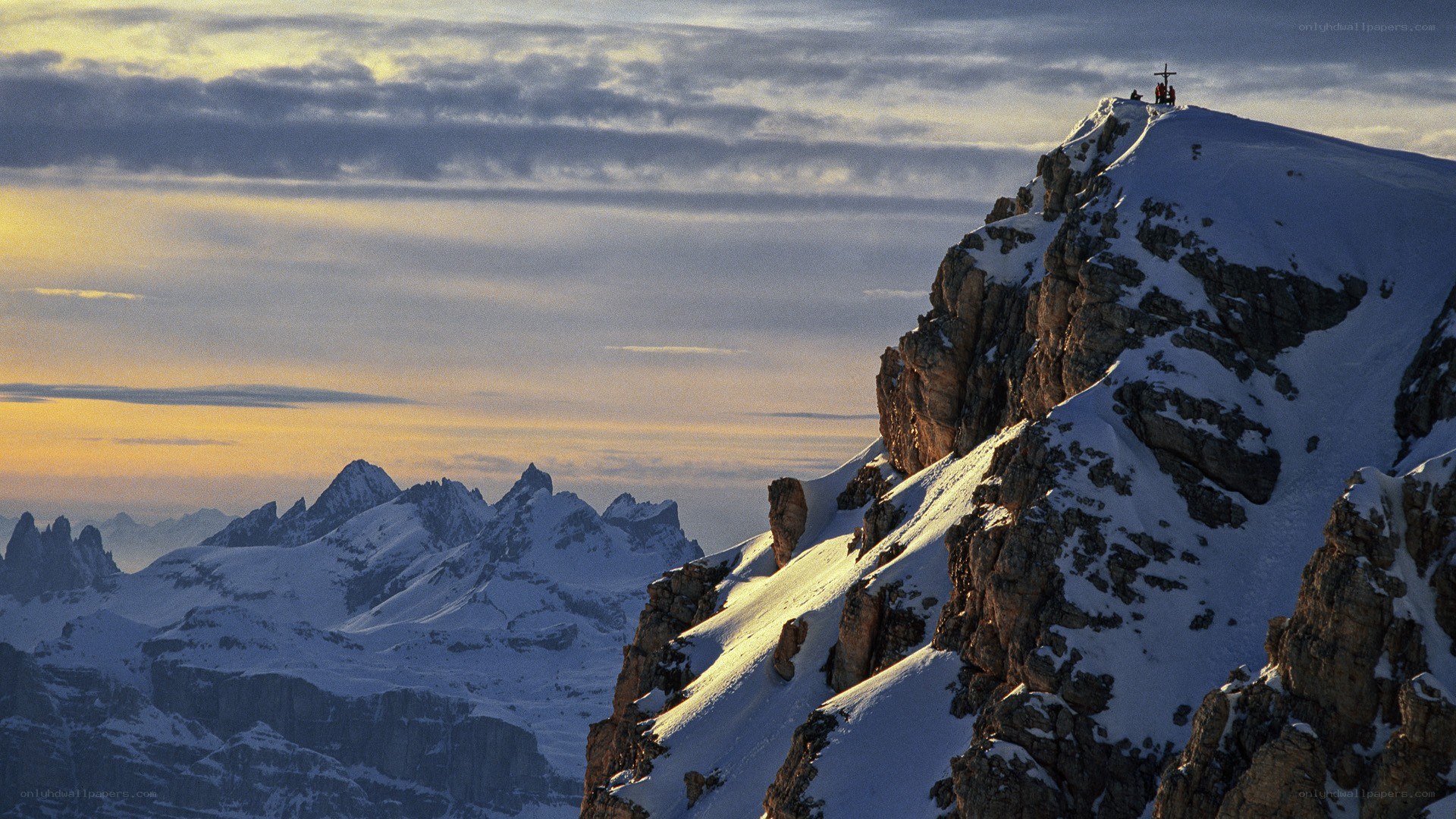 Snowy mountain peak at sunset