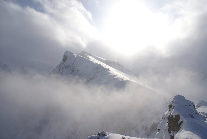 Snowy mountain peak in clouds
