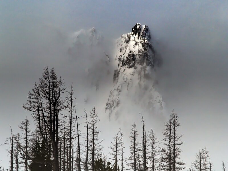 Snowy mountain peak in fog