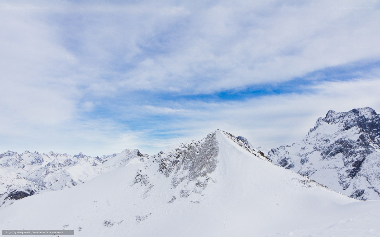 Snowy mountain peak under blue sky