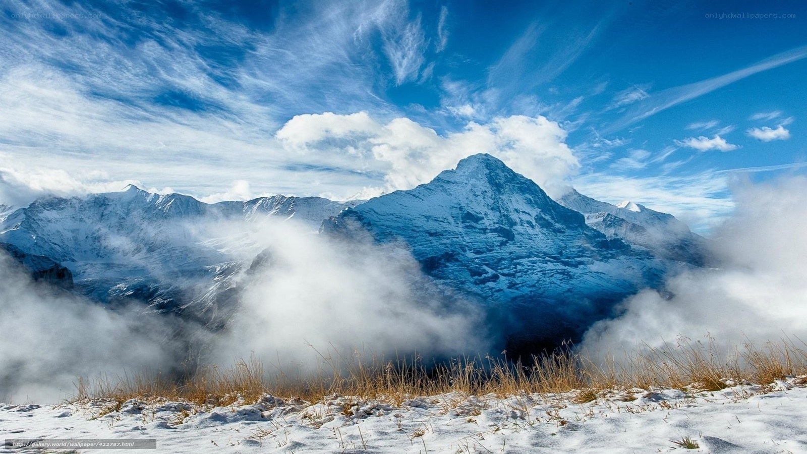 Snowy mountain peak under blue sky