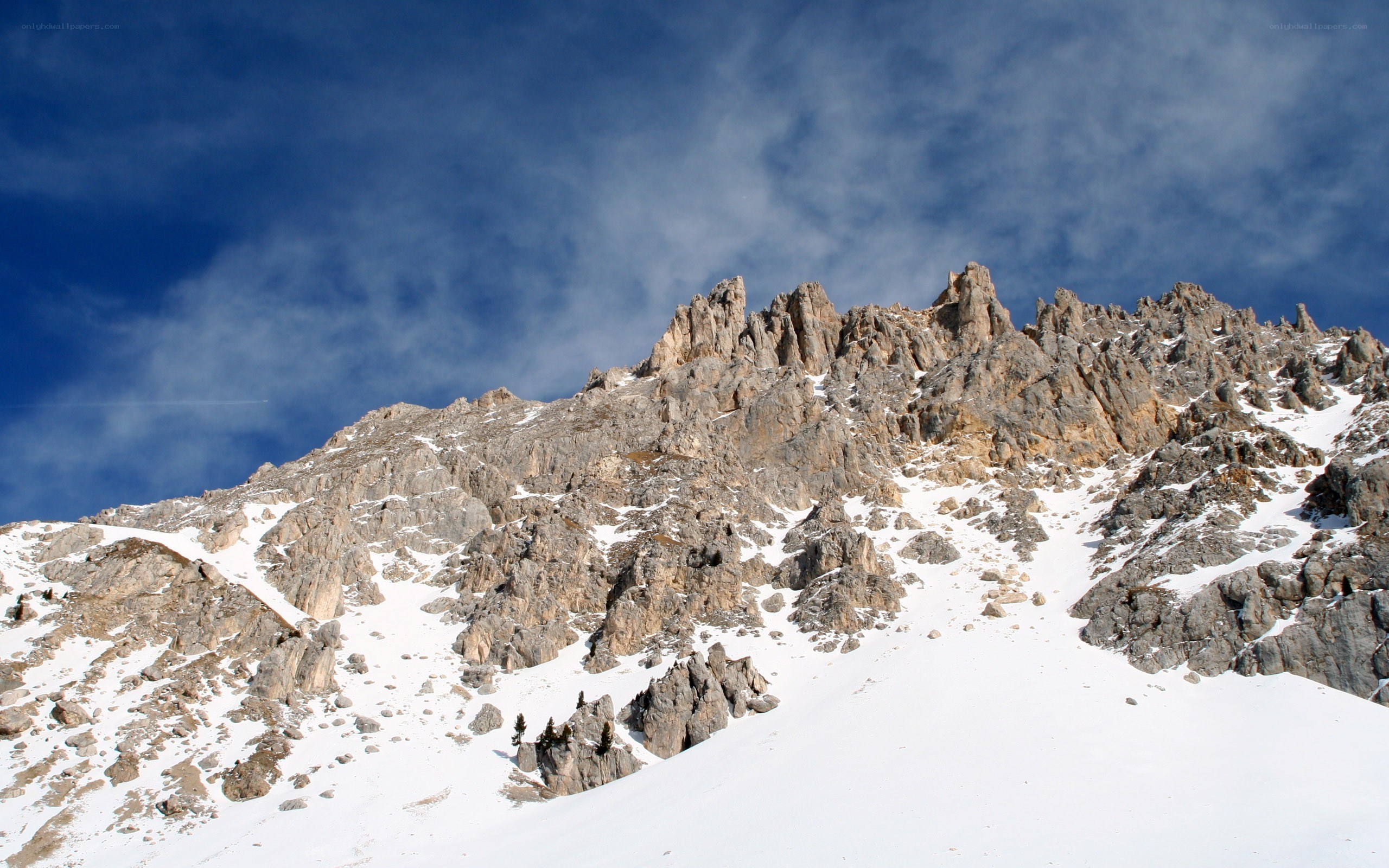 Snowy mountain peak under blue sky