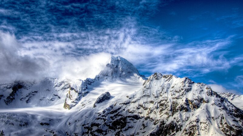 Snowy mountain peak under blue sky