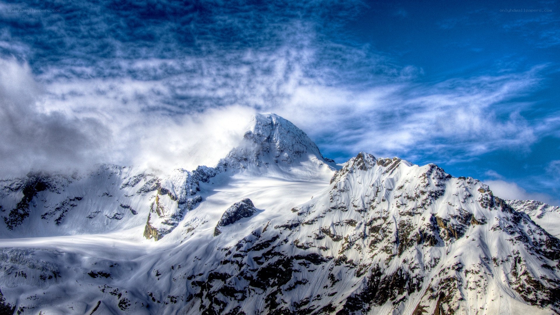 Snowy mountain peak under blue sky
