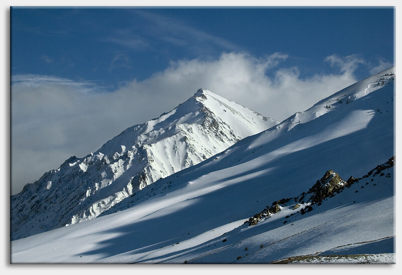 Snowy mountain peak under blue sky