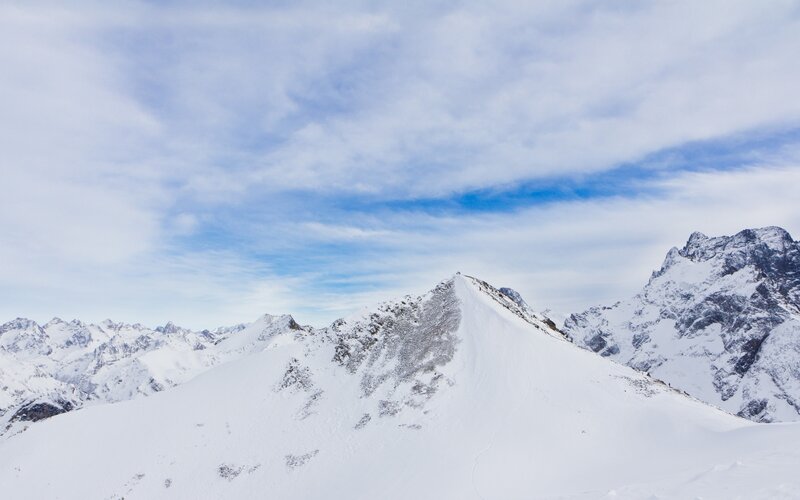Snowy mountain peak under blue sky