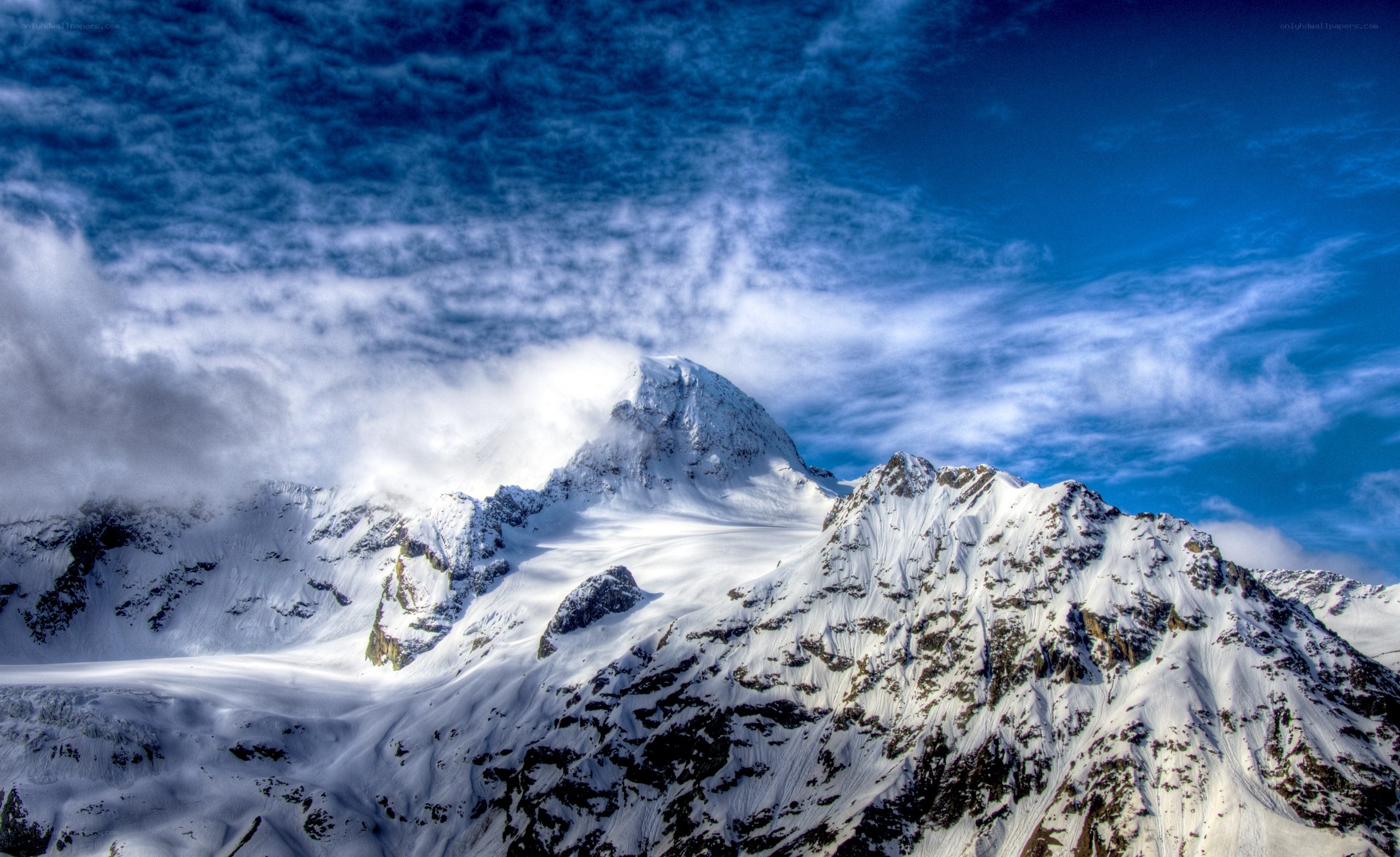 Snowy mountain peak under blue sky